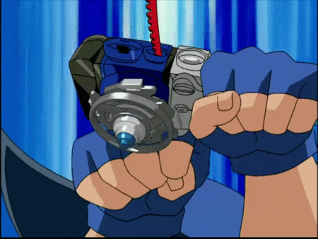 a person in a blue glove is holding a spinning top in their hand