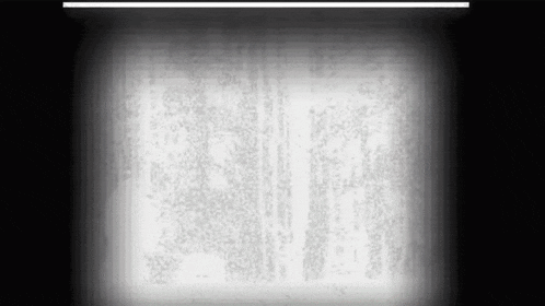 a black and white image of a projector screen with a light coming out of it .