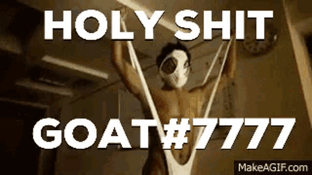 a man in a mask is hanging from a string with the words holy shit goat # 777 written on it .