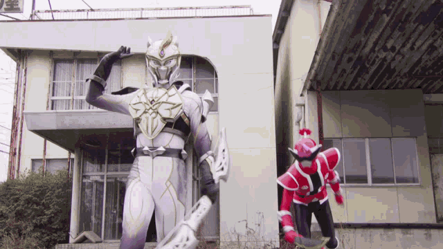 a red and white superhero stands in front of a white building