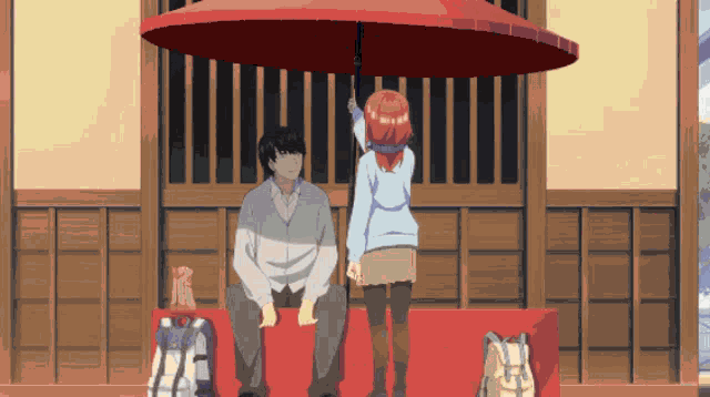 a man and a girl sit under an umbrella
