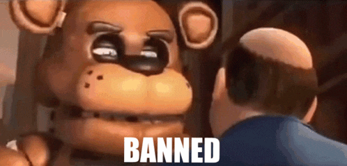 a man is standing next to a teddy bear with the words banned on it
