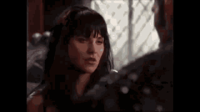 a man and a woman are looking at each other in a dark room .