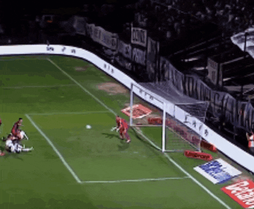 a soccer game is being played in a stadium with a banner that says ' eae ' on it