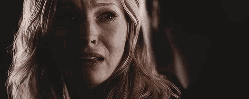 a close up of a woman 's face with tears running down her face .