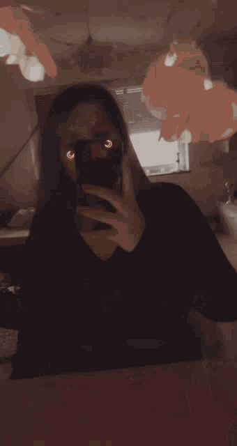 a woman taking a selfie in a mirror