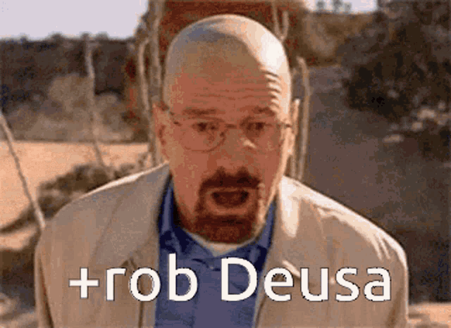 a man with glasses and a beard is standing in front of a sign that says + rob deusa .