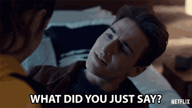 a man laying on a bed with the words " what did you just say " on the bottom