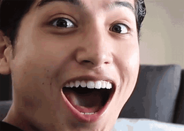 a close up of a man 's face with a surprised look on his face