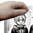 a close up of a person 's hand holding a picture of a boy in a suit .