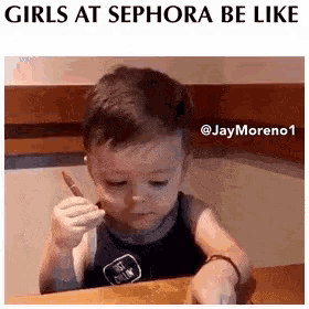 a little boy sitting at a table with a pencil in his hand and a caption that says girls at sephora be like