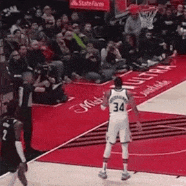 a basketball player wearing a number 34 jersey is standing on the court .