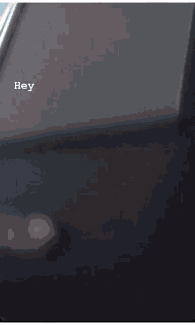 a close up of a person wearing a face mask and a hat that says hey on the bottom