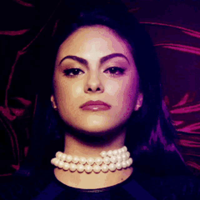 a woman wearing a choker with pearls around her neck .