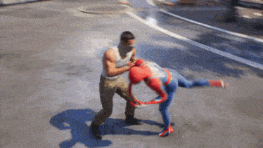 a man in a white tank top is fighting a spider man