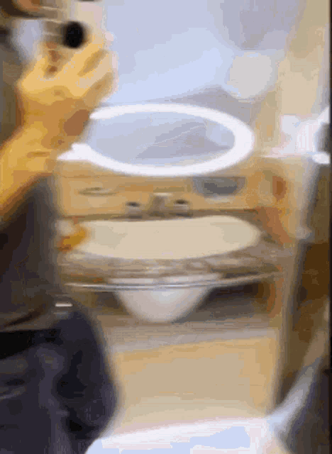 a blurred image of a person using a blender in a kitchen .