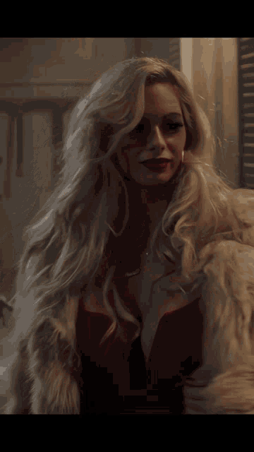 a woman in a red dress and white fur coat