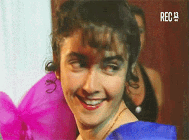 a woman in a blue dress is smiling and rec 19 is visible on the bottom right