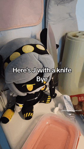 a stuffed animal with the words here 's j with a knife bye