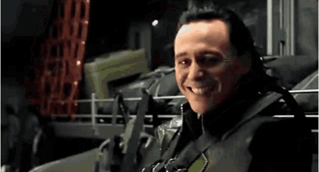 a close up of a man in a black suit smiling .