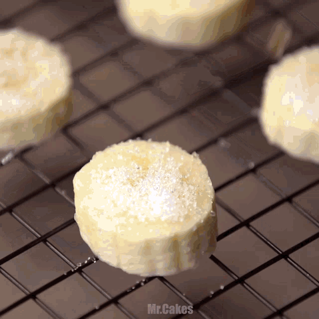 a close up of sliced bananas on a cooling rack with the words mr.cakes below them