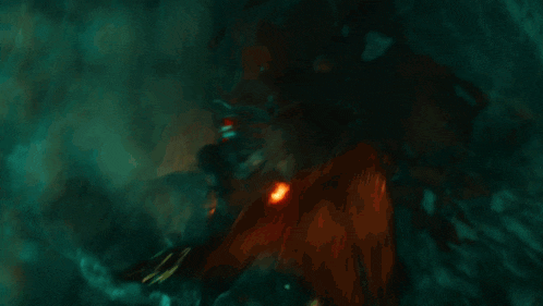 a man in a black suit is holding a torch in his hand