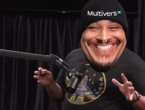 a man wearing headphones is laughing in front of a microphone while standing in front of a brick wall .