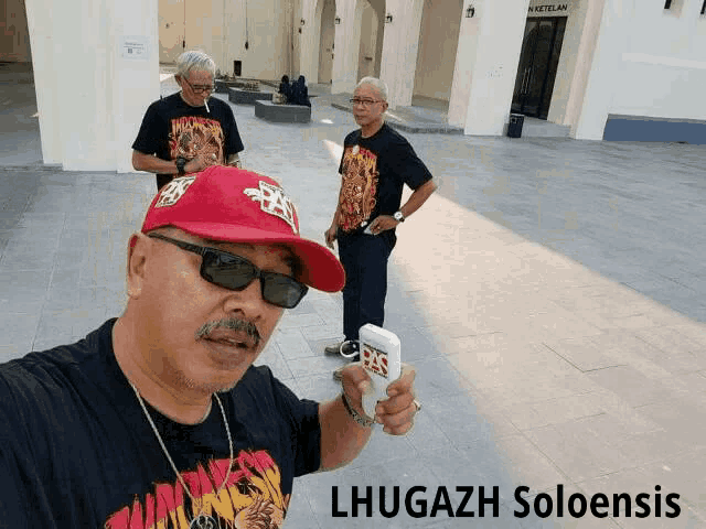 three men standing in front of a building with the words lhugazh soloensis on the bottom right
