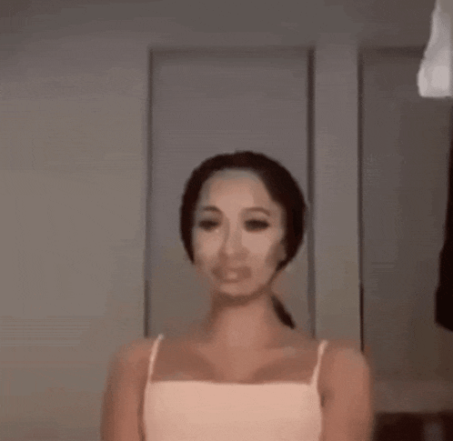 a woman wearing a mask on her face is standing in front of a door .