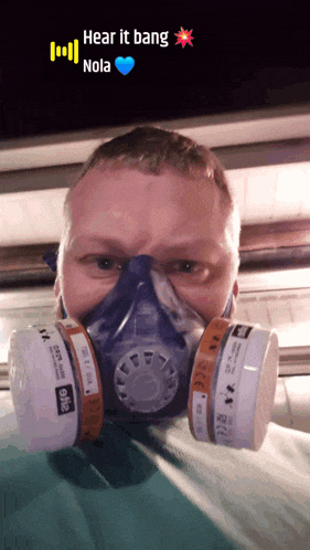 a man wearing a gas mask with the words hear it bang nola on the bottom