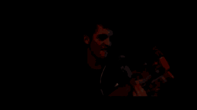 a blurry picture of a person 's face in the dark .