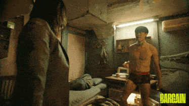 a man without a shirt is standing next to a woman in a room that says bargain on the bottom