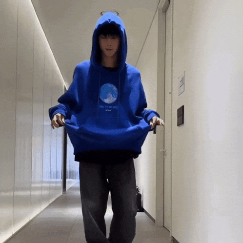 a person wearing a blue hoodie that says " i love you "
