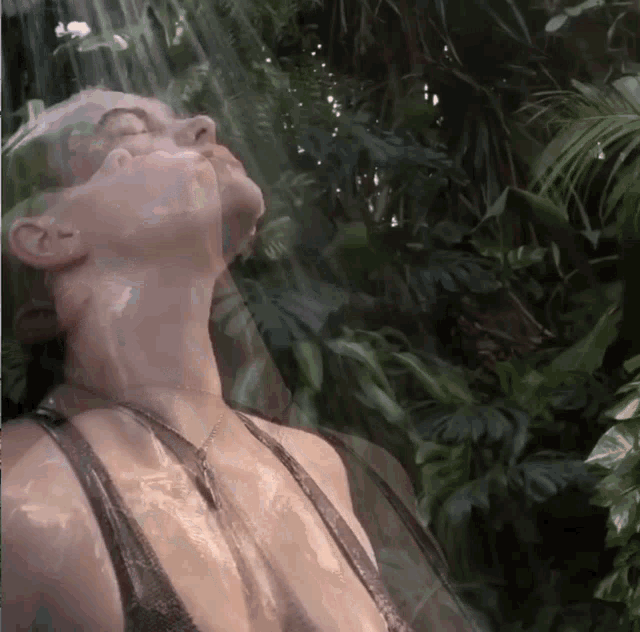 a woman with her eyes closed is surrounded by trees and leaves