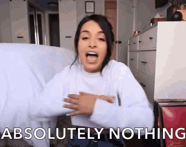 a woman says absolutely nothing while sitting on a bed