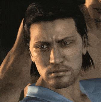 a close up of a man 's face with a blue shirt on
