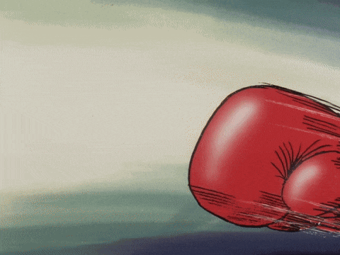a close up of a red boxing glove on a blue surface
