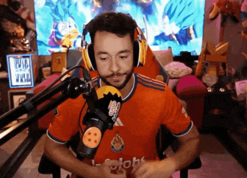 a man wearing headphones and an orange shirt with the word globe on the front