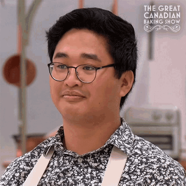 a man wearing glasses and a floral shirt is on a tv show called the great canadian baking show