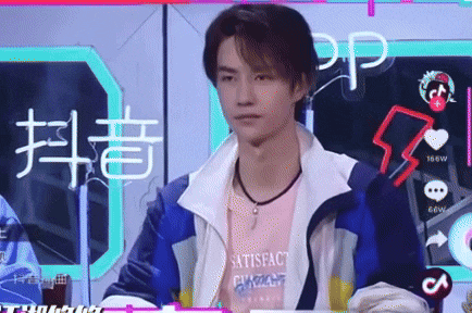 a man wearing a jacket and a t-shirt that says satisfaction