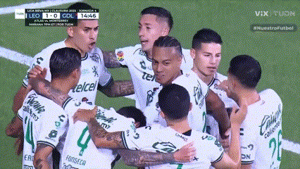 a group of soccer players are huddled together on a field with telcel written on their shirts