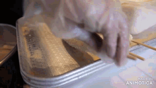 a person is cutting a piece of meat with a knife .