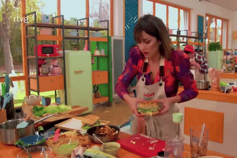 a woman in an apron that says ' goya ' on it prepares food in a kitchen