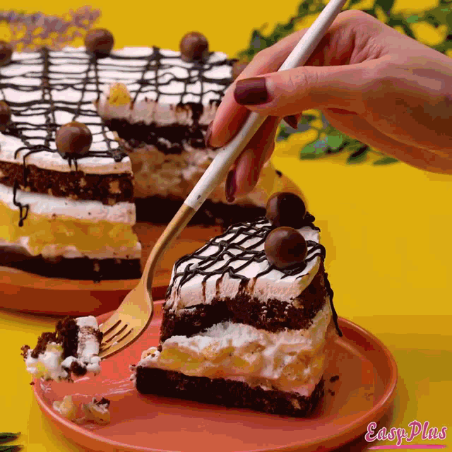 a person is taking a piece of cake with a fork from a plate that says easy plus on it