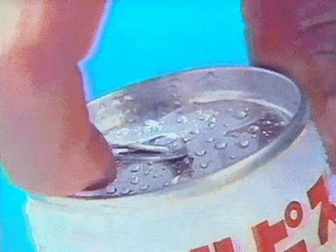 a person is opening a can of pop soda