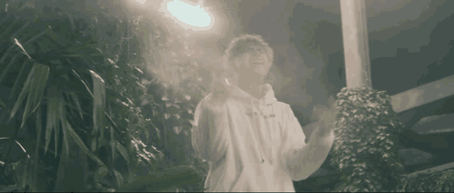 a person wearing a white hoodie that says ' a ' on the front