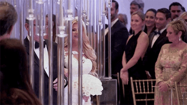a bride is walking down the aisle at her wedding