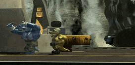 a video game scene with a blue monster and a yellow monster fighting