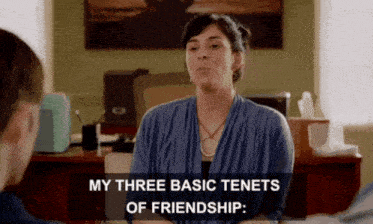 a woman sitting at a desk with the words " my three basic tenets of friendship "