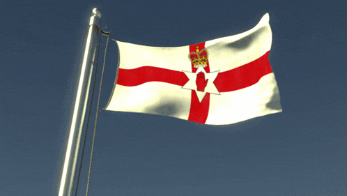 a white and red flag with a crown on it is waving in the wind